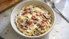 Tagliatelle w kremowym sosie z boczkiem i pieczarkami – prosty obiad z patelni